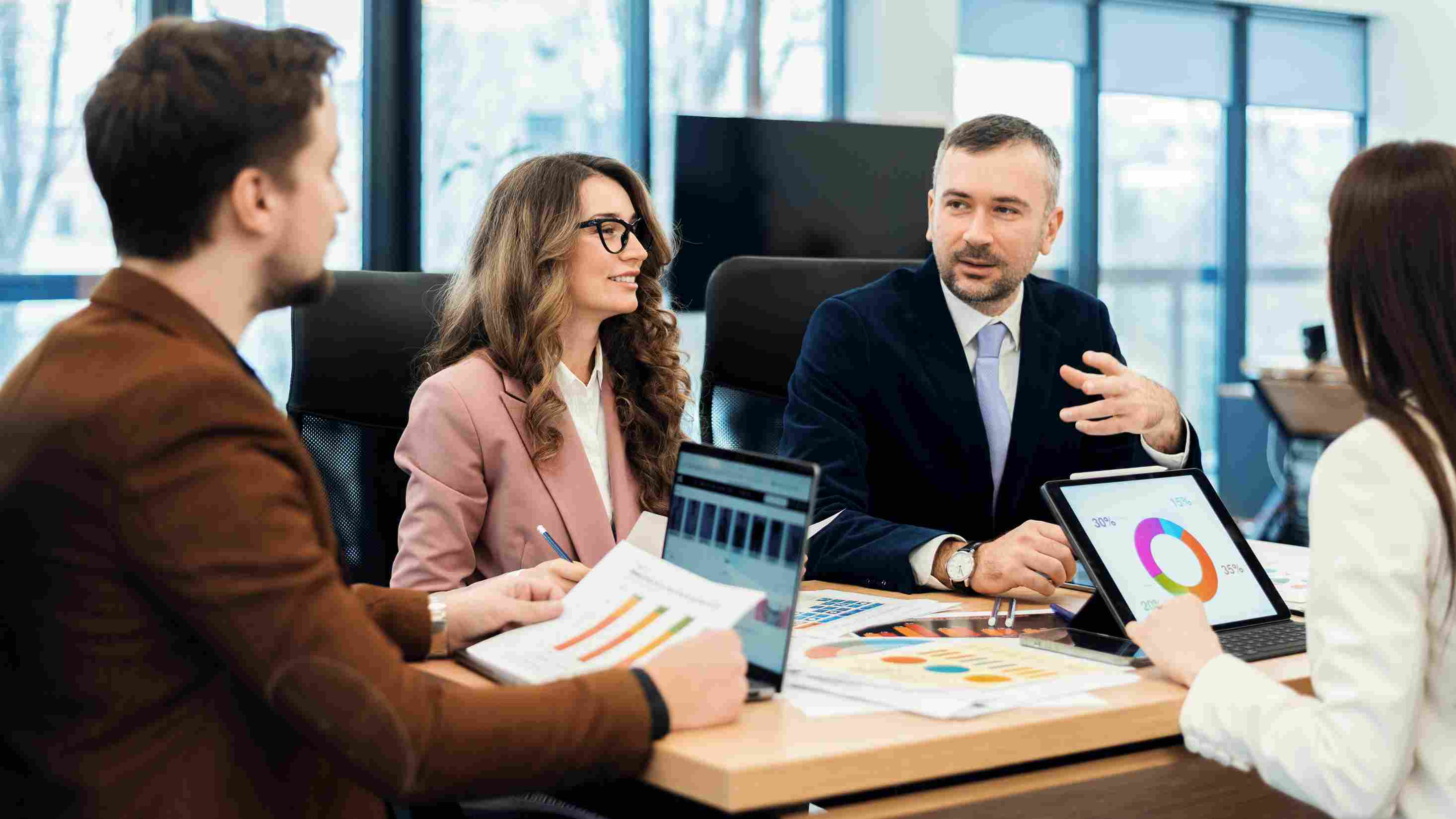 Outsourced CFO consultant discussing financial options with an Abu Dhabi management team